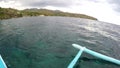 Boat outriggers moving through ocean waves